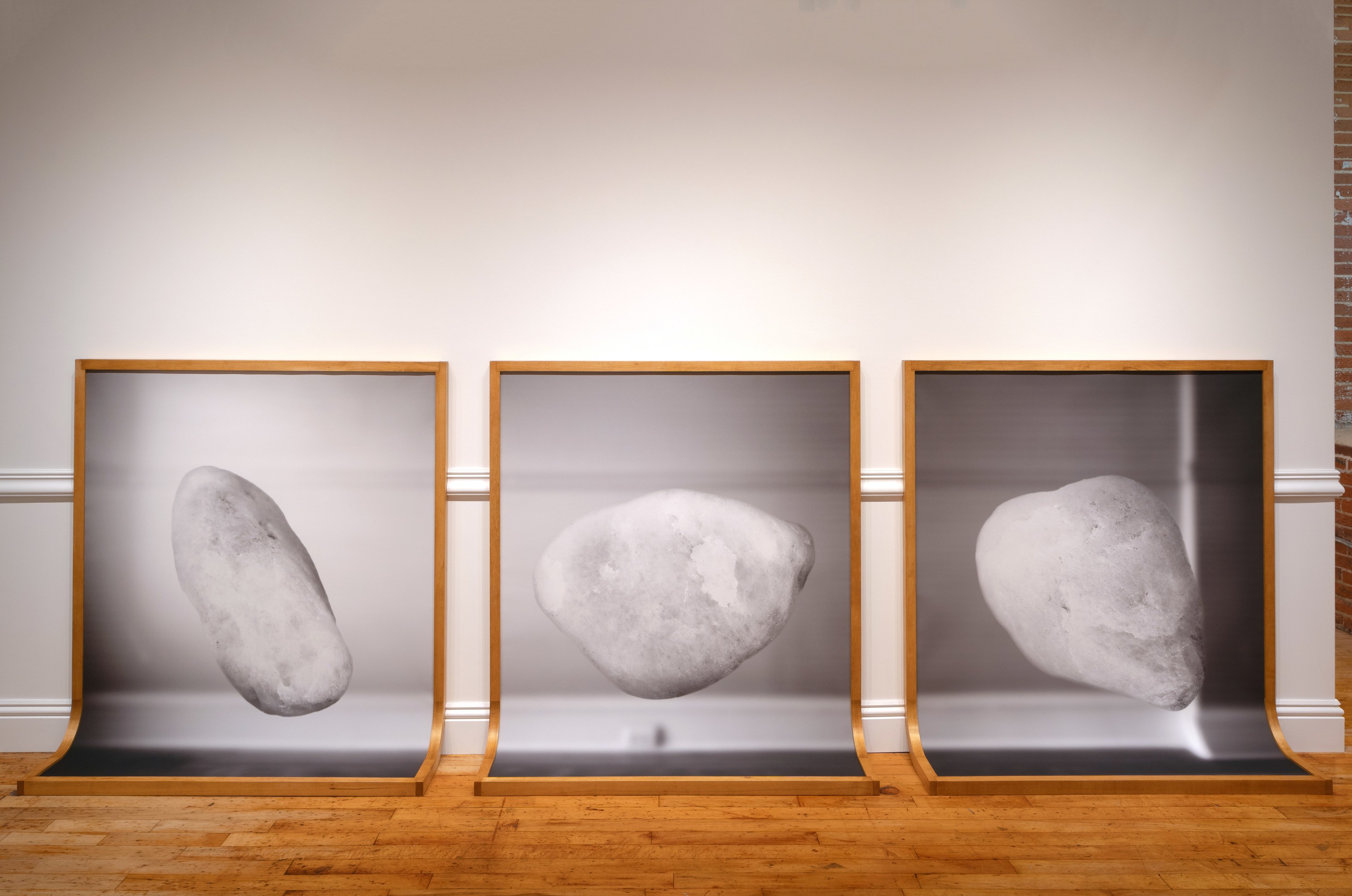 3 framed prints curving to become the floor and the wall.
