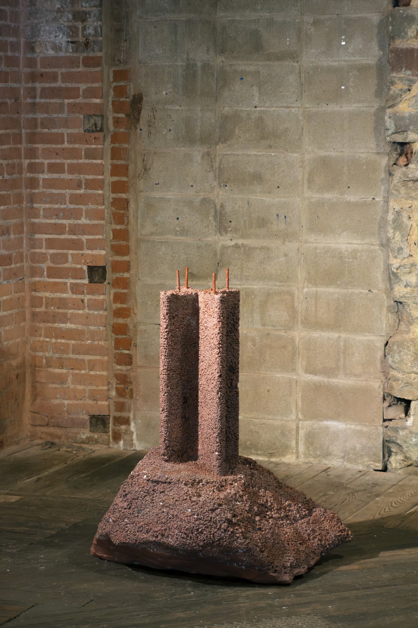 A large rock with a plus shaped column emerging from it.